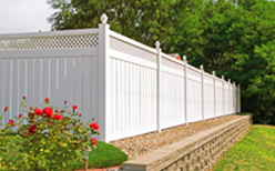 White Vinyl Fencing in Bloomington IL next to a garden