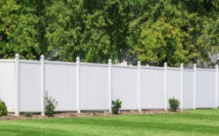 View of Fences in Peoria IL Positioned in Front of Several Large Trees