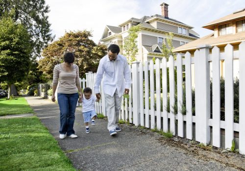 Young family walking in front of vinyl fencing in Bloomington IL