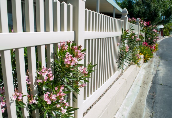 Beautiful, white vinyl fence with flowers, installed at a residential household in Illinois