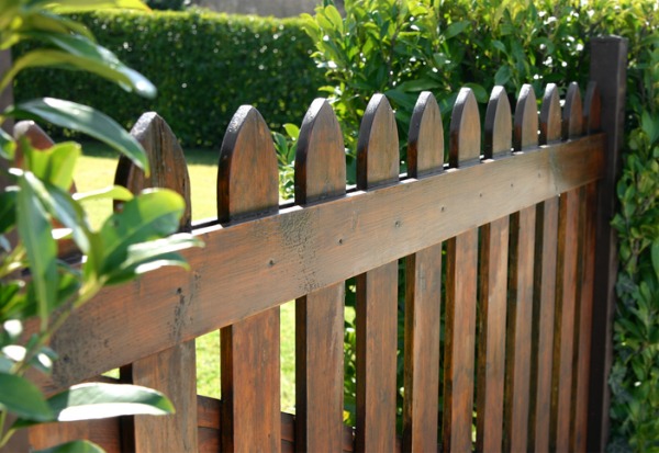 A new picket fence made from copperwood, installed in a yard in Illinois