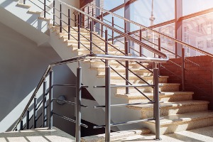 A modern staircase with new commercial railings installed by Hohulin Fence